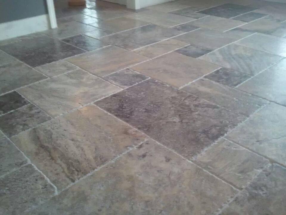 Multi-tone stone-look tile floor in a staggered pattern